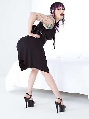 Clothed & inked goth girl hikes her black dress to reveal pierced pussy