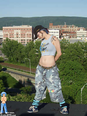 Hip chick strips, spreads wide on rooftop