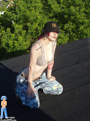 Hip chick strips, spreads wide on rooftop