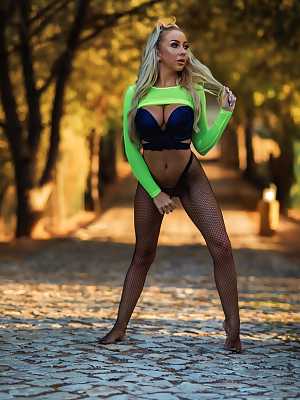 Hot blonde Beth Morgan performs a strip tease on a tree lined roadway