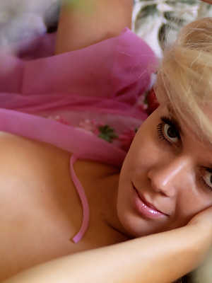 Adorable blonde Avis Miller displays her natural tits while posing on the bed