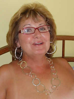 Naked older lady Busty Bliss proudly shows off tan lined body in glasses