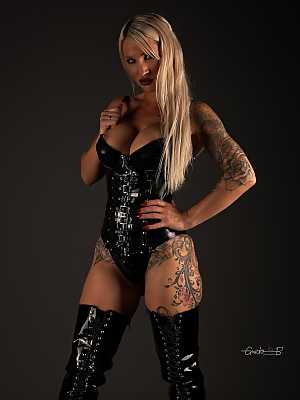Sexy tattooed blonde models latex fetish wear and matching thigh high boots