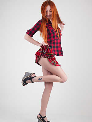 Redheaded schoolgirl Micca shows her big tits and poses nude on a chair