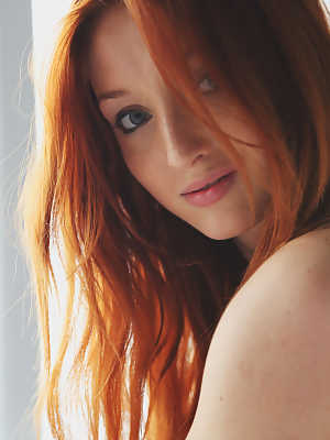 Pale redhead Micca strikes tempting poses while totally naked on her bedsheets
