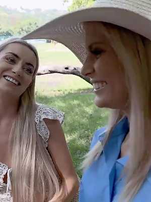 Lesbians Candee Licious & Emilly Bellex share a double-ended dildo outdoors