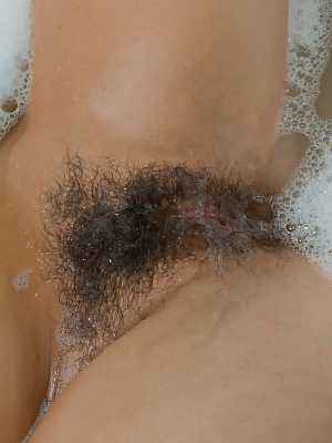 Hotly busty Candy disrobes in the tub & soaps her hot naked ass & hairy twat