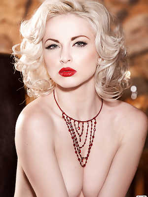 Glamorous platinum blonde with pale skin slipping off her lingerie