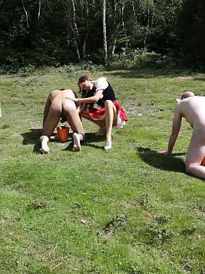 Horny femdom girls in costume head to the field to milk their naked man slave