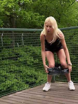 Blonde girl Carol Lilien pulls down her cutoffs for a piss on a wooden walkway