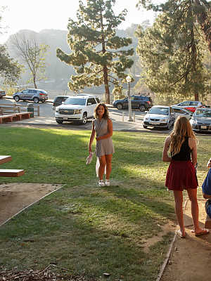 Attractive Latina teen Carol Jasabe posing in her tight white dress outdoors