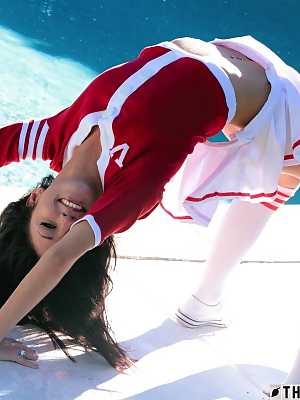 Brunette cheerleader Catie Minx exposes her tight ass near a swimming pool