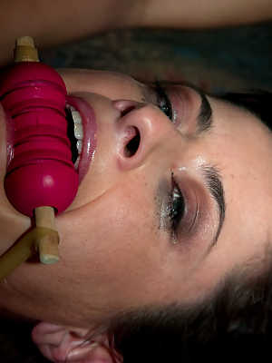 A gagged and restrained Cecilia Vegais is covered in heart shaped wax