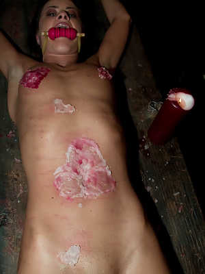 A gagged and restrained Cecilia Vegais is covered in heart shaped wax
