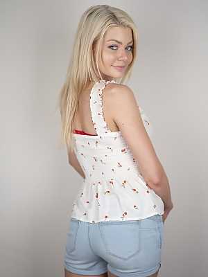 Sexy blonde Riley Steele posing in her white top and jean shorts