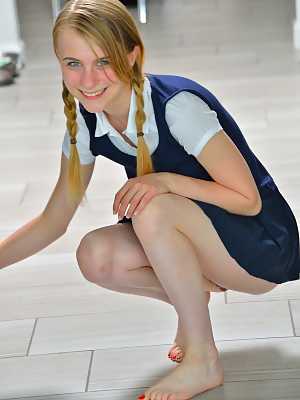 Tiny schoolgirl Sharlotte in uniform bends over for a naked upskirt outside