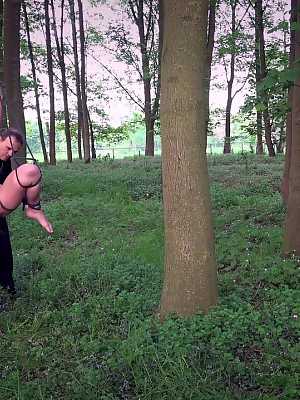 Female sub Christie Starr rope bound in woods for painful whipping & face fuck