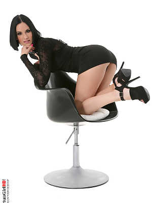 Hot brunette Claire Castel cups a firm boob while stripping on swivel chair