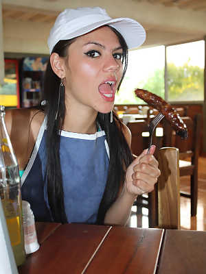 Tempting young teen Latina Claudia Castro eats a sausage provocatively