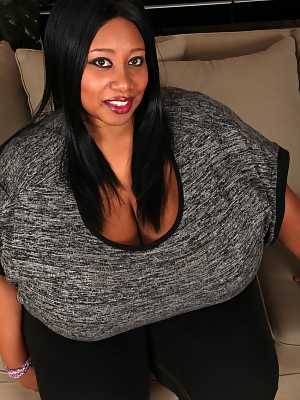 Ebony BBW Cotton Candi lets out her huge boobs in solo action on the floor