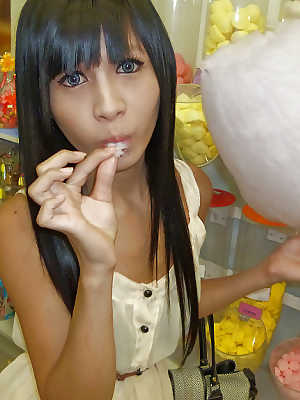 Cute Asian tranny Noot eating cotton candy and posing in high heels