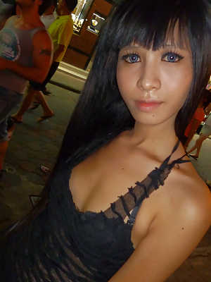 Cute petite Asian ladyboy flashing her body on the public streets