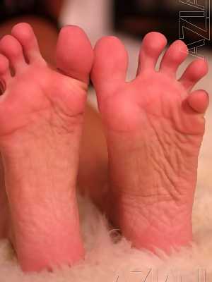 Brunette pornstar Crissy Moran licks her toes after revealing her fake titties