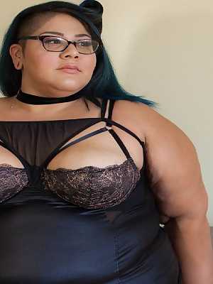 Tattooed SSBBW Crystal Blue teasing with her juicy natural tits in glasses