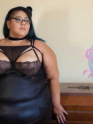 Tattooed SSBBW Crystal Blue teasing with her juicy natural tits in glasses
