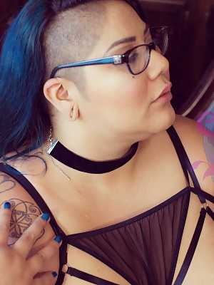 Tattooed SSBBW Crystal Blue teasing with her juicy natural tits in glasses