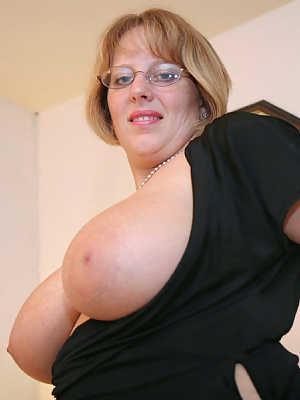 Fat UK lady Curvy Claire sets her huge tits loose in sheer nylons and glasses