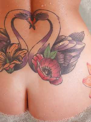 Tattooed solo girl Daniella Mae releasing big tits from bikini in bathroom