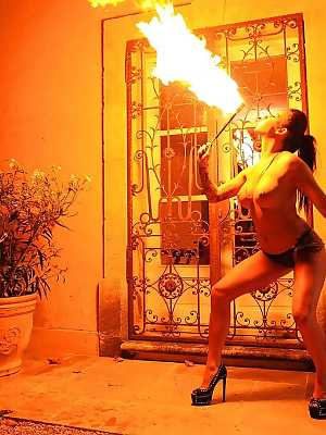 European fire breather Daniella Mae displaying big tits and pierced nipples