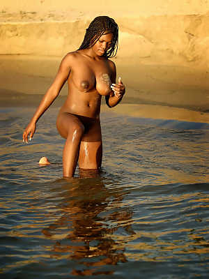 African beauty Deserea A reveals her juicy tits and poses on the beach
