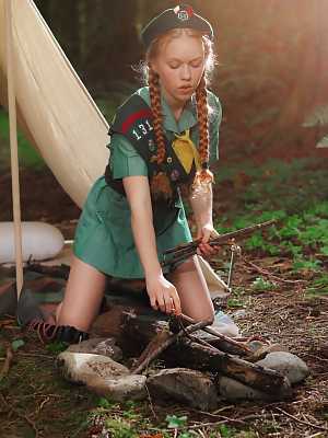 Redheaded Girl Scout Dolly Little gets naked outside her tent in beret