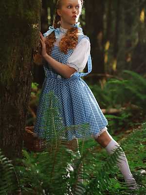 Charming redhead teen Dolly Little gets naked in white socks while in a forest