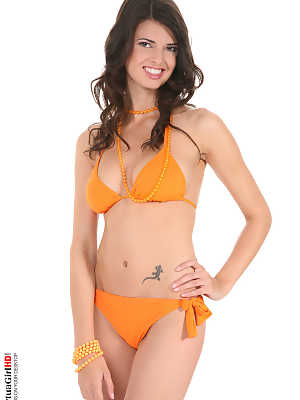 Beautiful girl with long legs Jasmine Andreas takes off her bikini