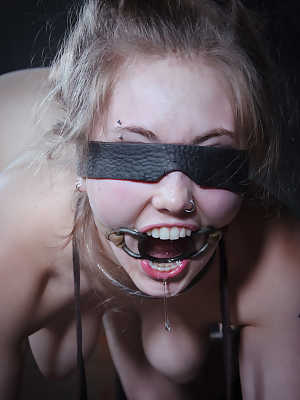 Naked girl Electra Rayne finds herself blindfold while being used as a slave