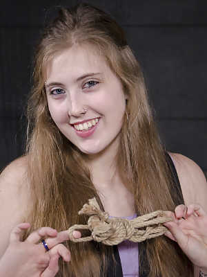 White girl Electra Rayne is tied up with ropes in a dungeon by a black man