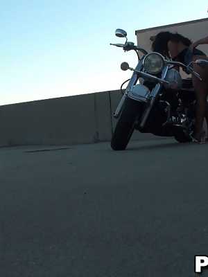 Lovely dark haired chick with big tits sucking and riding dick on the bike