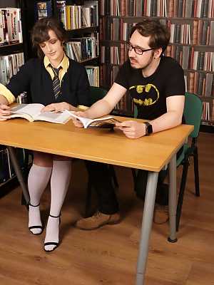 Nerdy women strip and jerk off a fellow nerd in the library