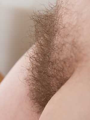 Appealing dark haired diva Ella Martin stretches her hairy pussy up close