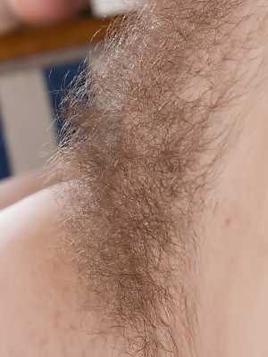 Appealing dark haired diva Ella Martin stretches her hairy pussy up close