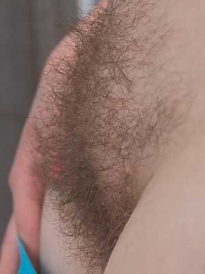 Beautiful brunette Ella Martin takes a mud bath smearing it on her hairy pussy