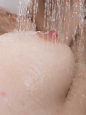 Beautiful brunette Ella Martin takes a mud bath smearing it on her hairy pussy