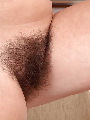 Mature woman Elle Macqueen proudly displaying her really hairy pussy