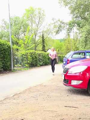 Blonde girl Emily Bright pulls down leggings beside a car for an urgent pee