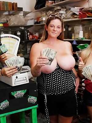 Busty chick Emily Kae and her gf weigh their boobs in store for cash money