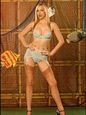 Hot blonde Emily Marilyn shows her big tits in a garter belt and tan nylons