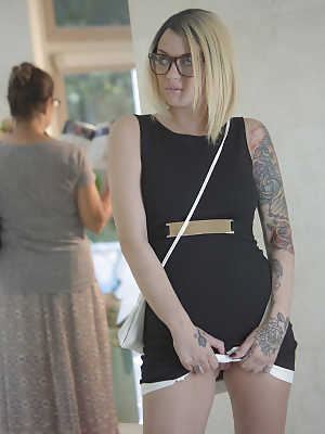 Glasses wearing tattooed blonde Emma Mae exposing large all natural tits